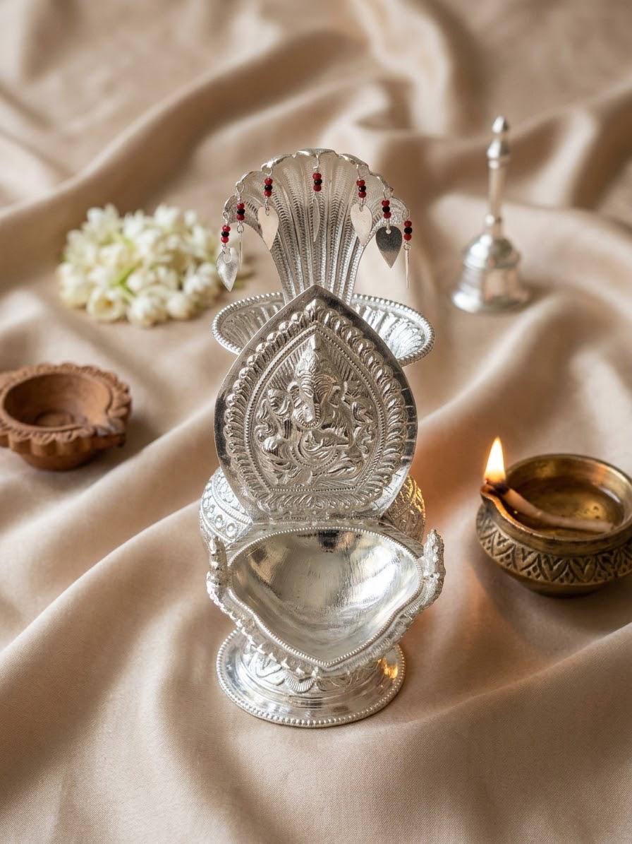 Silver Ganesh diyo with embossed Lord Ganesh and hanging leaf charms